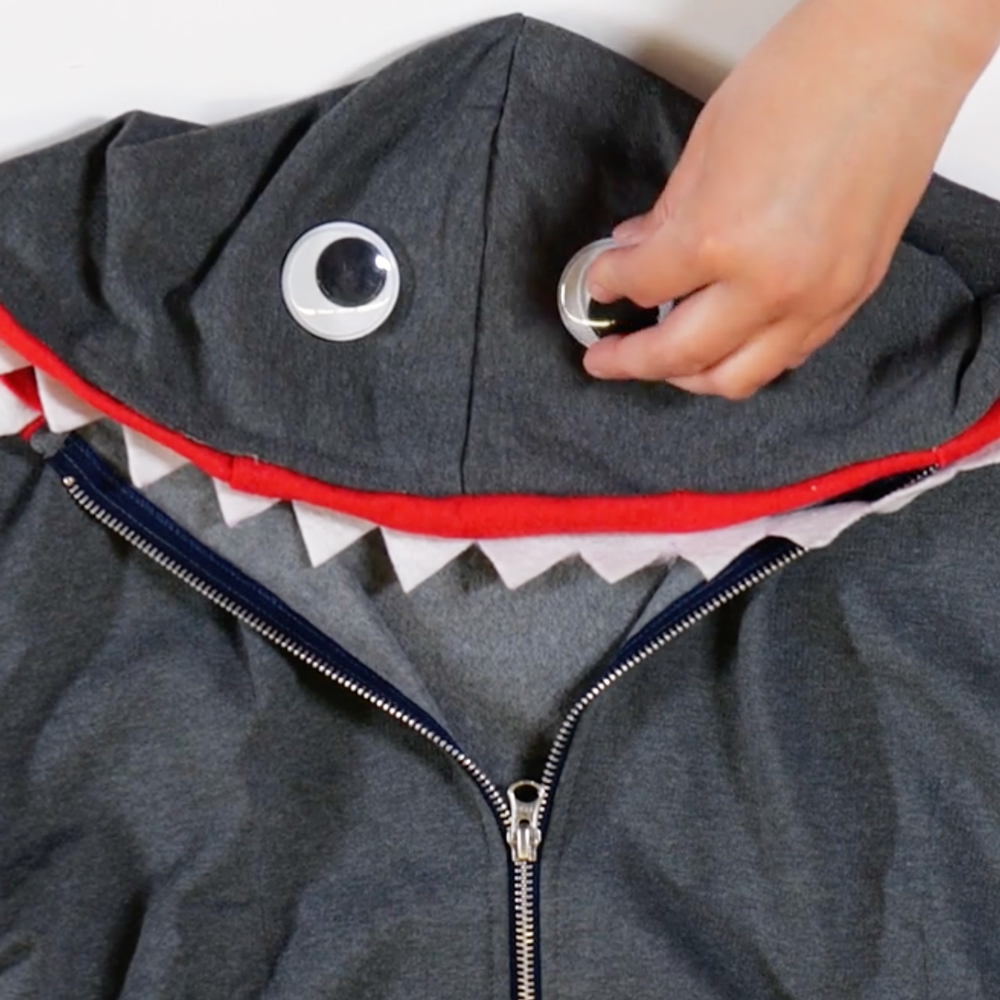 glue googly eyes to the hood of sweatshirt